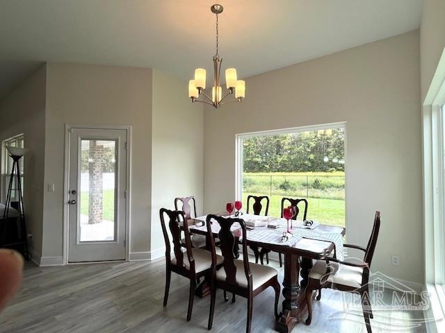 dining room featuring hardwood / wood-style floors and a chandelier