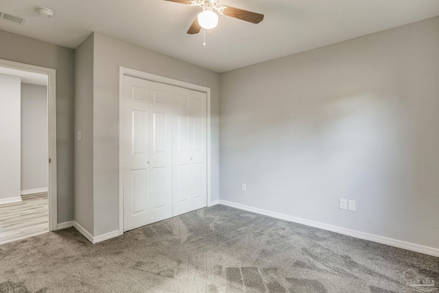 unfurnished bedroom with carpet floors, ceiling fan, and a closet