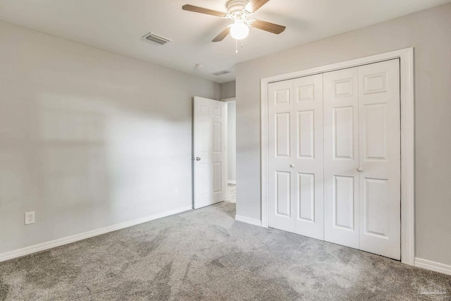 unfurnished bedroom featuring carpet floors, a closet, and ceiling fan