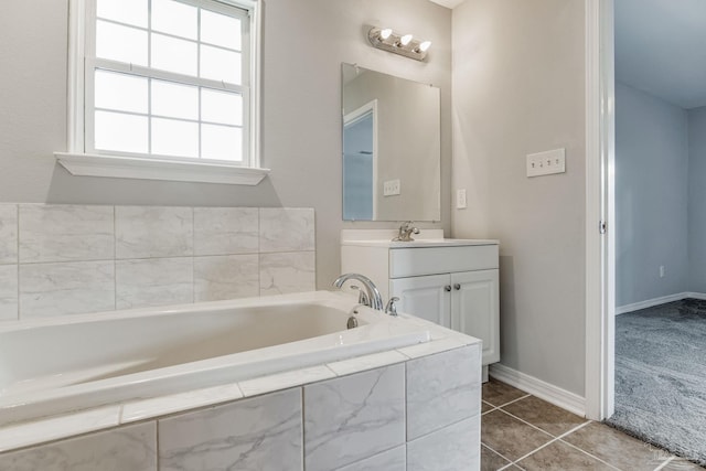 bathroom with tile patterned floors, tiled bath, and vanity