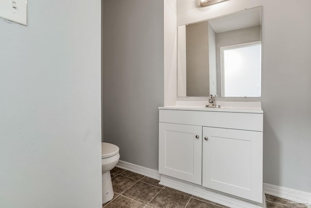 bathroom with vanity, tile patterned flooring, and toilet