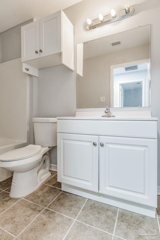 bathroom with tile patterned floors, vanity, and toilet