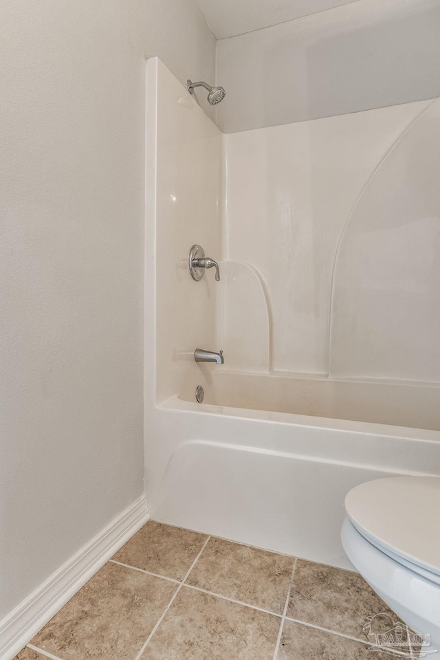 bathroom with bathtub / shower combination, tile patterned floors, and toilet