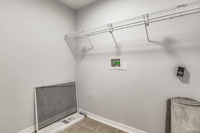 laundry room featuring washer hookup and dark tile patterned floors