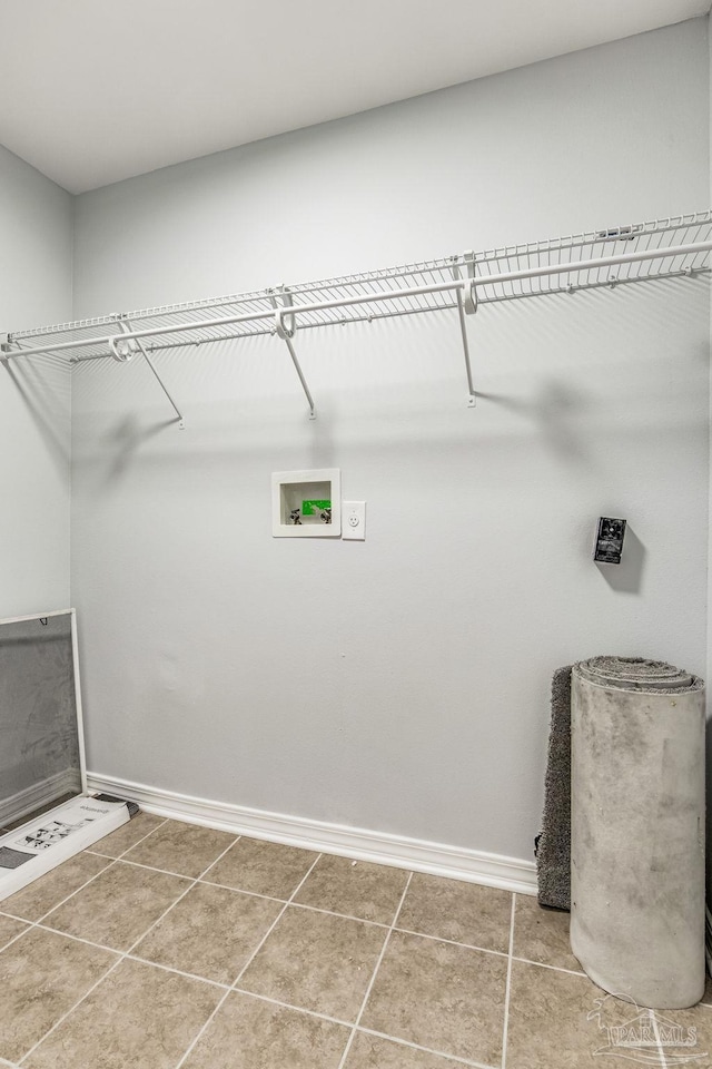 clothes washing area featuring tile patterned flooring and hookup for a washing machine