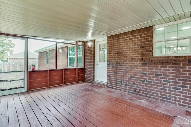 unfurnished sunroom featuring wood ceiling