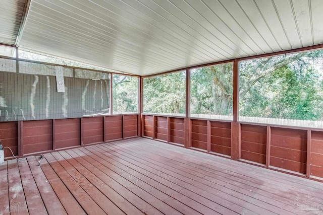 unfurnished sunroom featuring lofted ceiling