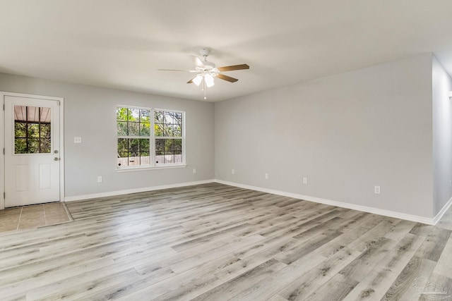 empty room featuring ceiling fan and light hardwood / wood-style floors