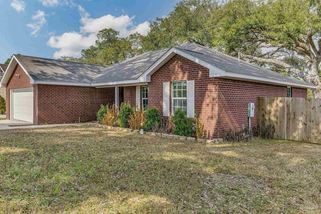 ranch-style house featuring a garage and a front lawn