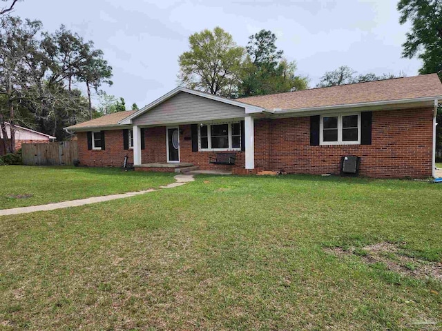 ranch-style home with a porch, brick siding, and a front yard