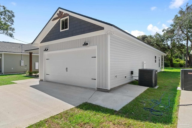 view of home's exterior with a lawn and central AC