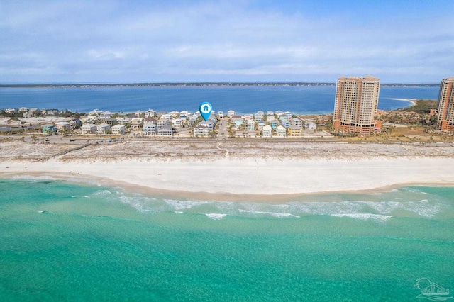 birds eye view of property featuring a beach view and a water view