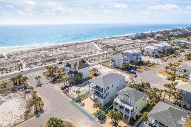 bird's eye view with a water view and a beach view