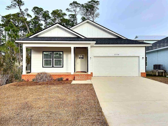 view of front of property with a garage and central AC unit