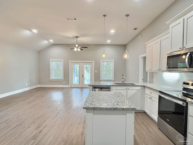 kitchen featuring pendant lighting, sink, white cabinets, kitchen peninsula, and stainless steel appliances