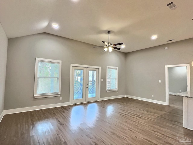 empty room featuring dark wood-type flooring, french doors, ceiling fan, and vaulted ceiling