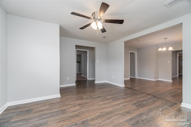 unfurnished room featuring baseboards, visible vents, dark wood-style flooring, and ceiling fan with notable chandelier