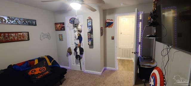 interior space featuring a ceiling fan, carpet, visible vents, and baseboards