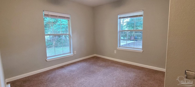 carpeted spare room with baseboards