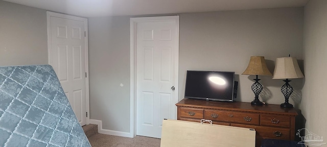 bedroom featuring carpet and baseboards