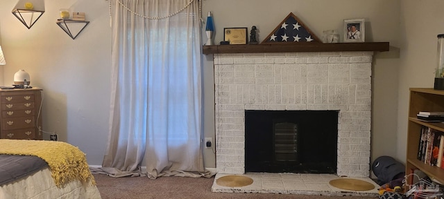 bedroom with carpet and a fireplace