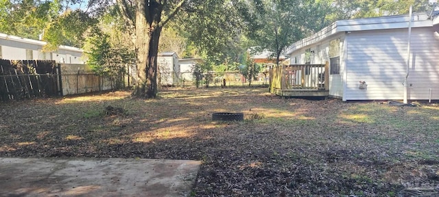 view of yard with fence and a wooden deck