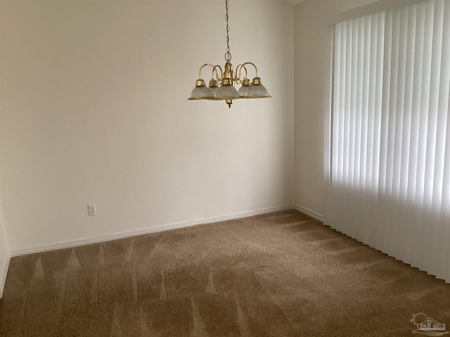 unfurnished room with an inviting chandelier, baseboards, and carpet flooring