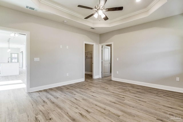 unfurnished room featuring light wood-type flooring and ornamental molding