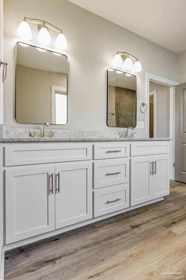 bathroom with vanity and hardwood / wood-style flooring