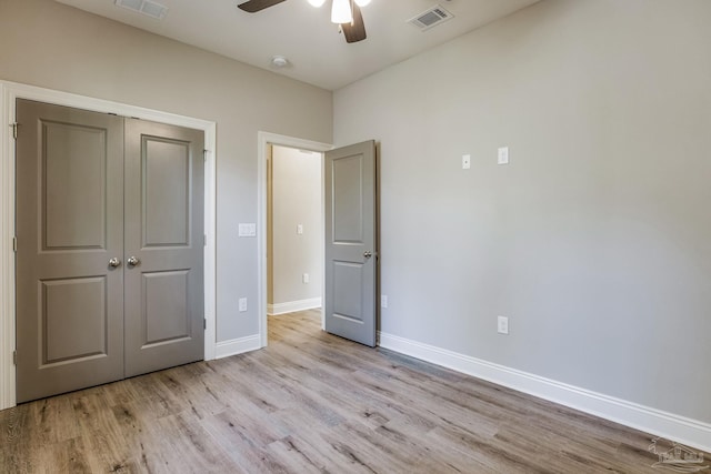 unfurnished bedroom featuring a closet, ceiling fan, and light hardwood / wood-style flooring