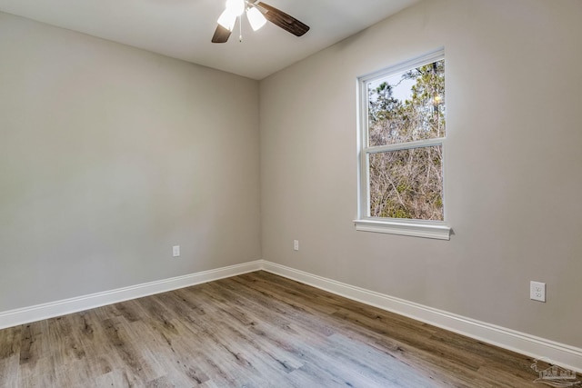 empty room with ceiling fan, plenty of natural light, and light hardwood / wood-style floors