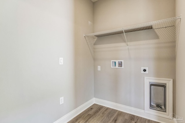 washroom with hookup for a washing machine, wood-type flooring, and hookup for an electric dryer