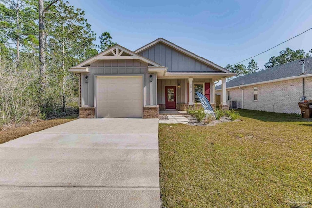 view of front of home with a porch, central AC unit, a front yard, and a garage