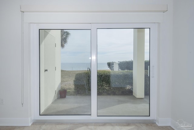 doorway to outside with a water view