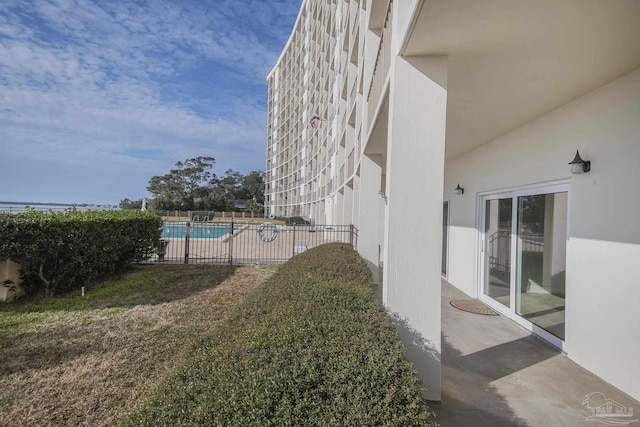 view of yard with a fenced in pool and a patio area