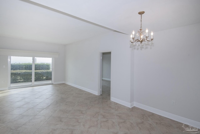 tiled spare room with a chandelier