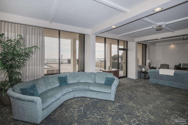 living room featuring expansive windows and beamed ceiling