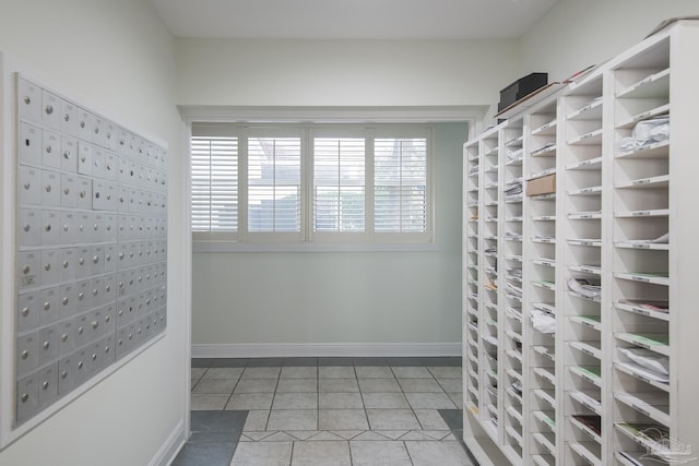 walk in closet featuring tile patterned floors and a mail area