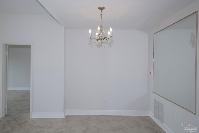 empty room featuring a notable chandelier