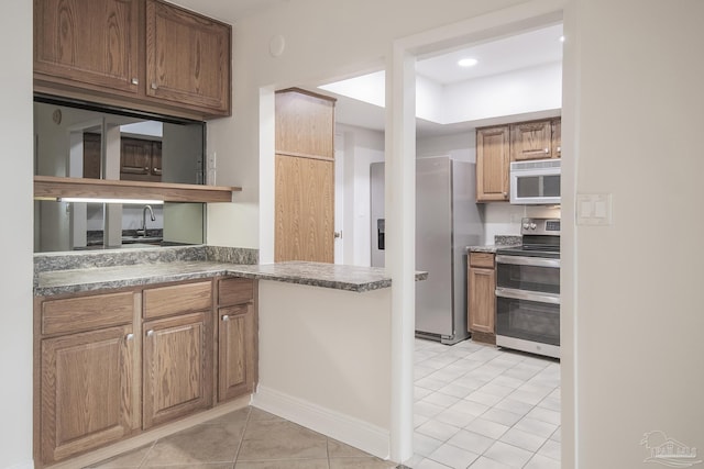 kitchen with stainless steel appliances and light tile patterned floors