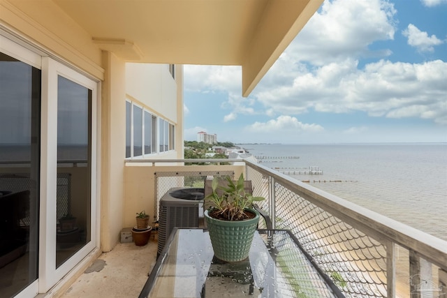 balcony with a water view and central AC unit