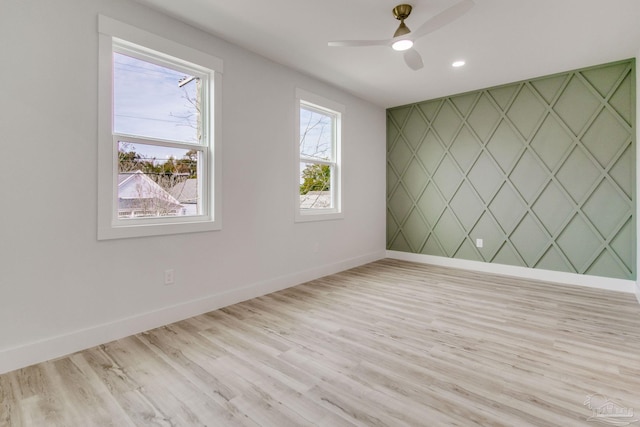 unfurnished room with light hardwood / wood-style flooring and ceiling fan