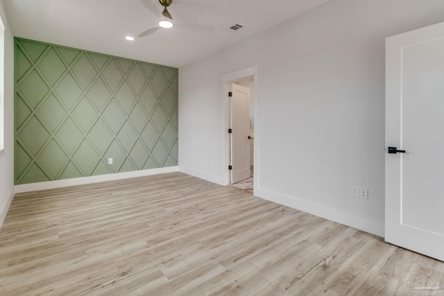 empty room featuring light hardwood / wood-style flooring and ceiling fan