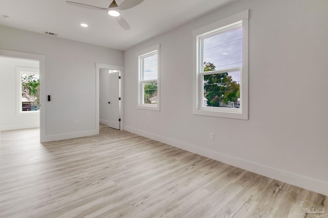 empty room with light hardwood / wood-style floors and ceiling fan