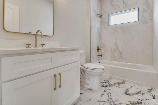 full bathroom featuring vanity, tiled shower / bath combo, and toilet