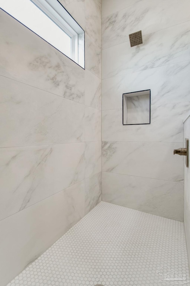 bathroom with tiled shower