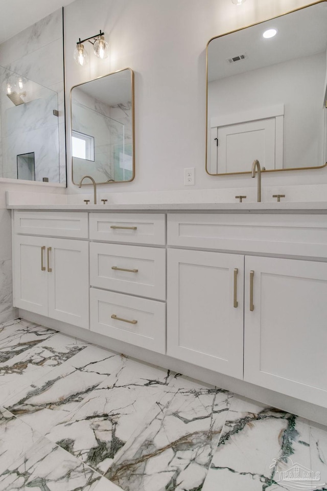 bathroom with vanity and a shower