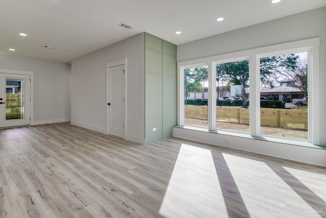 unfurnished room with light wood-type flooring