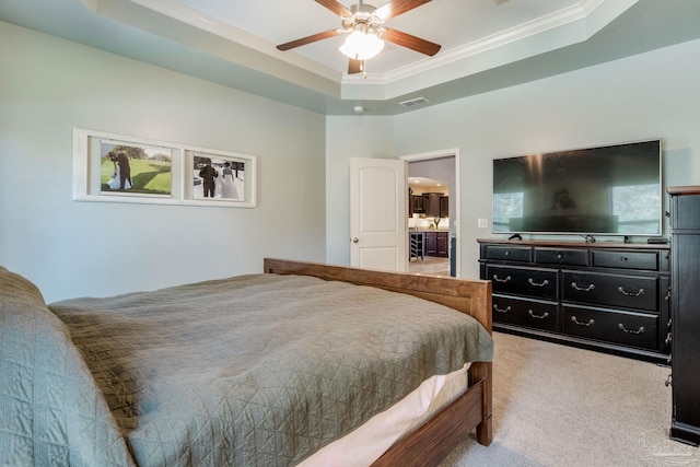 bedroom with light carpet, visible vents, arched walkways, ornamental molding, and a tray ceiling