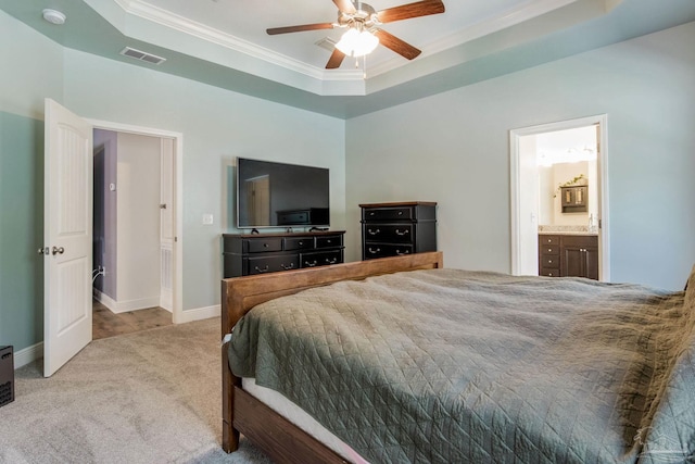 bedroom with visible vents, a tray ceiling, crown molding, and light colored carpet